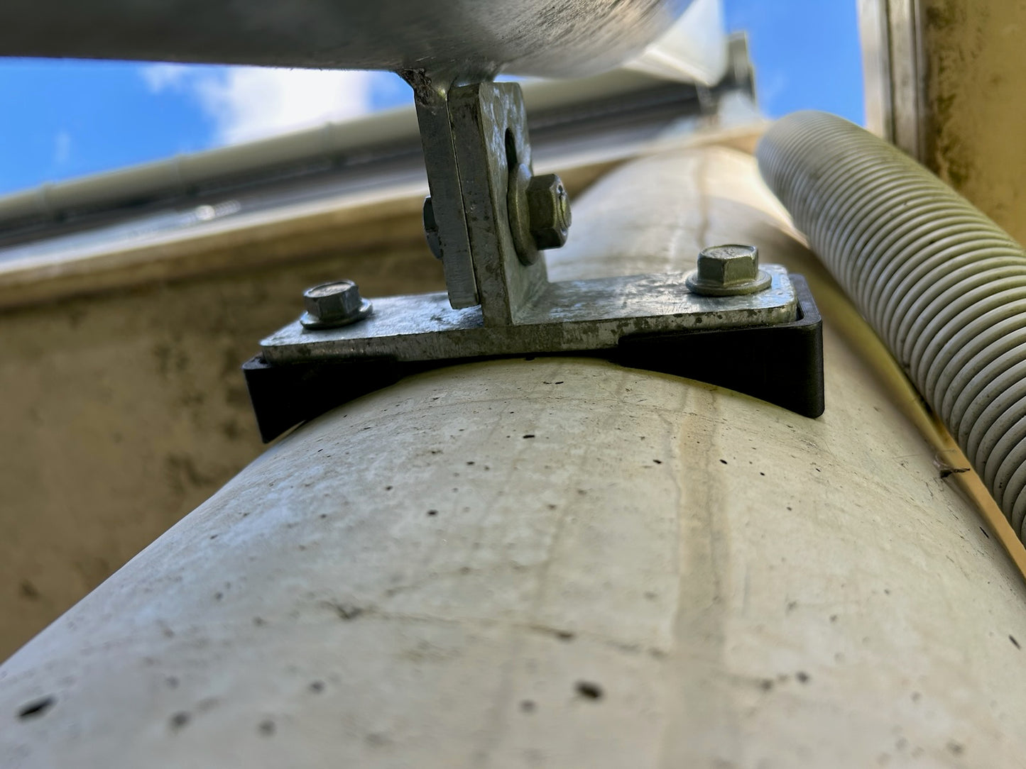 t bracket with printed spacers on round column for down pipe astragals